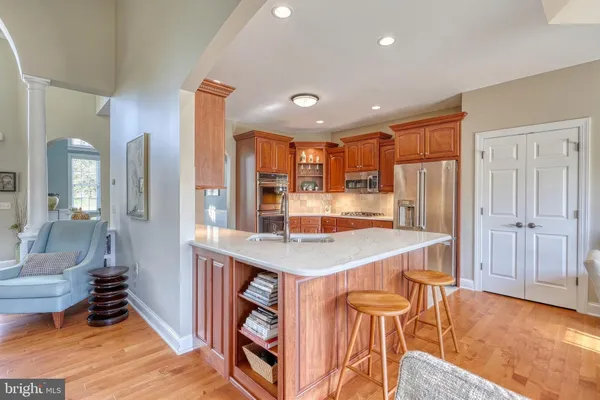 a kitchen with a table chairs and living room
