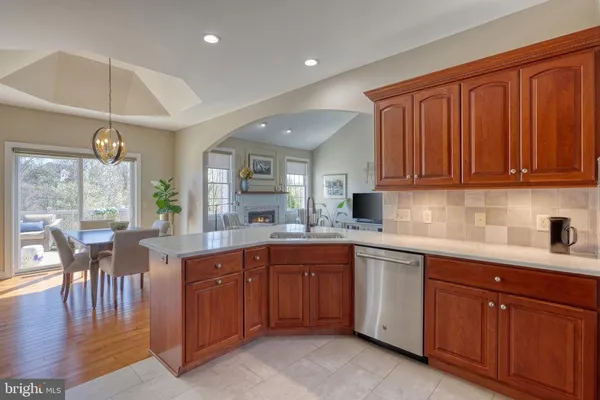 a kitchen with stainless steel appliances granite countertop a sink and a refrigerator