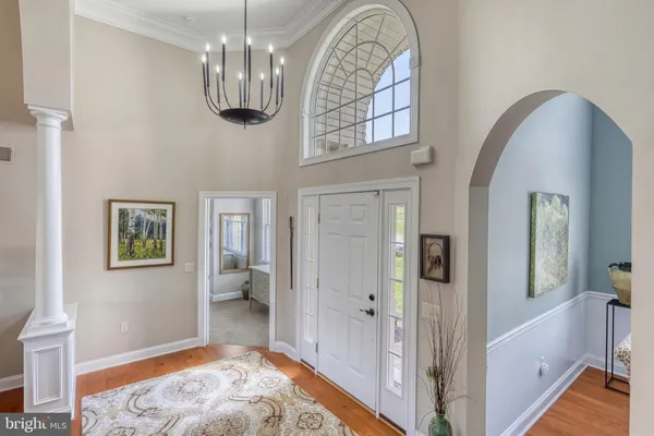 a bedroom with a large bed couch and a window