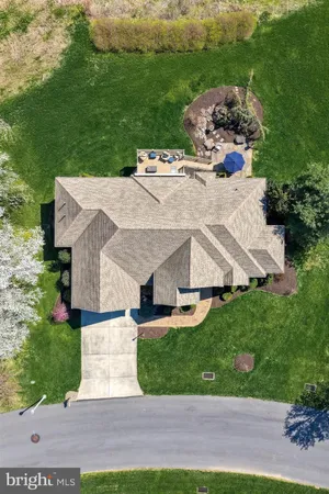 a aerial view of a house with a yard and garage