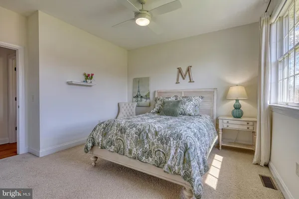a bedroom with a bed and a night stand