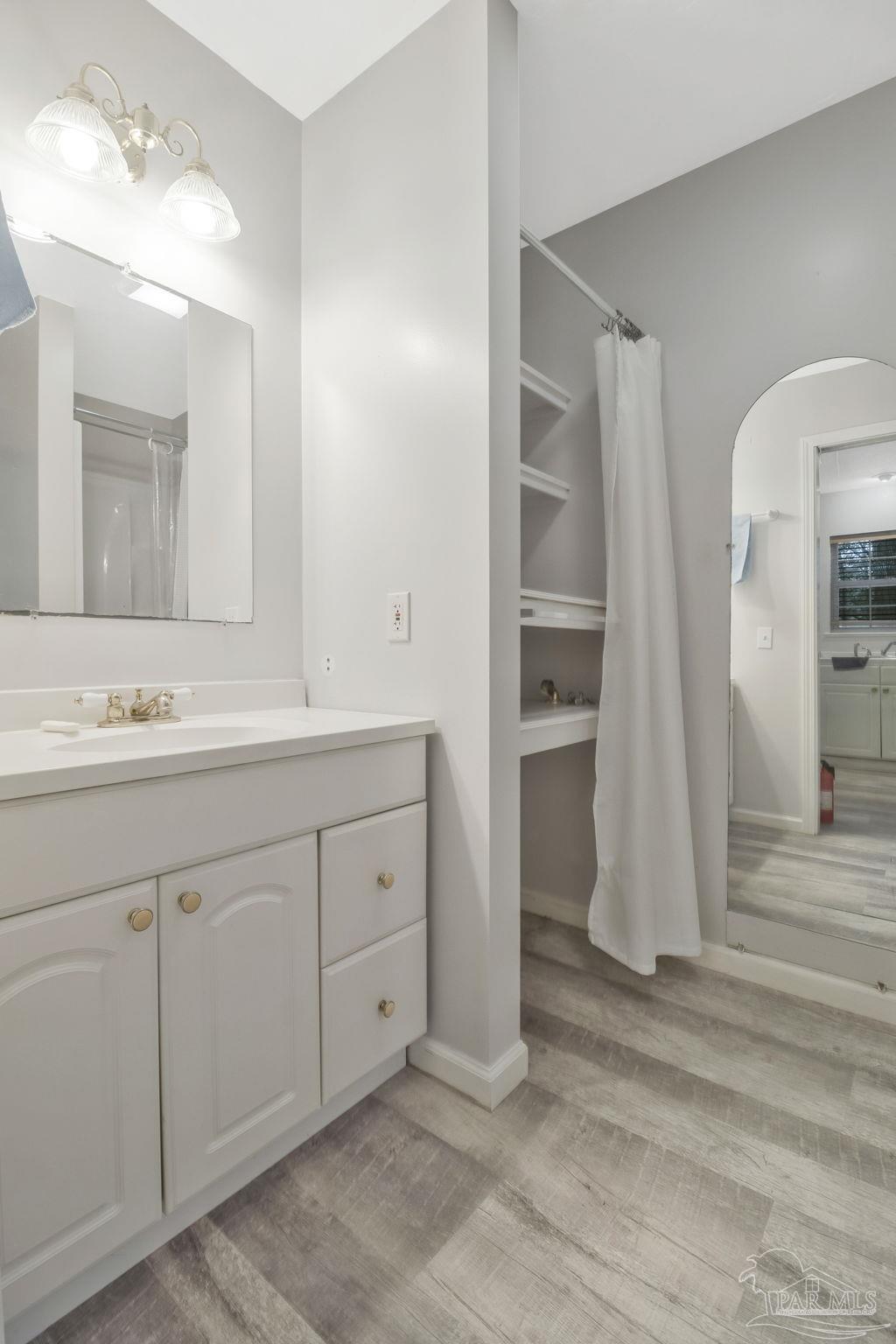 10290 West Lake Road Milton, FL 32583 - Photo 16 of 53 a spacious bathroom with a double vanity sink and a mirror