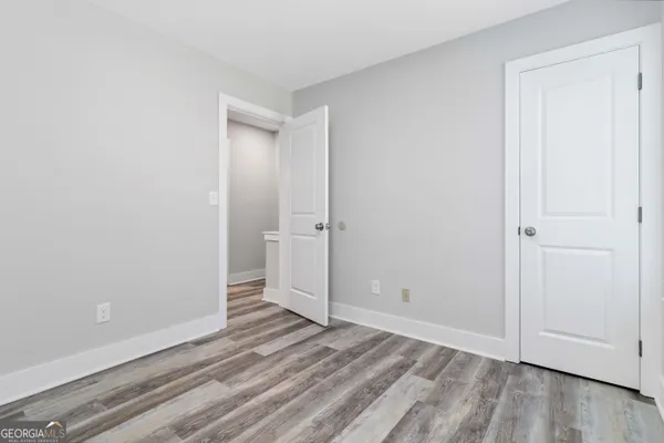 a view of a room with wooden floor and a bathroom