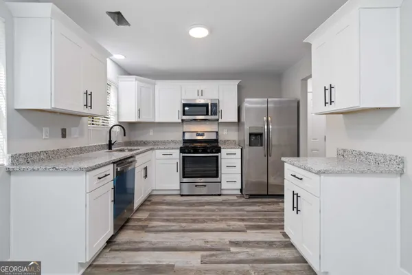 a kitchen with a sink stove and refrigerator