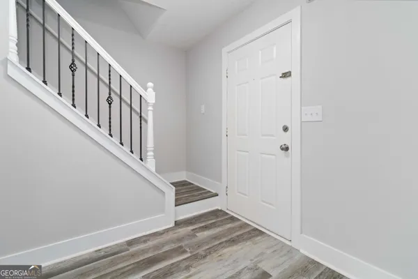 a view of an entryway with wooden floor