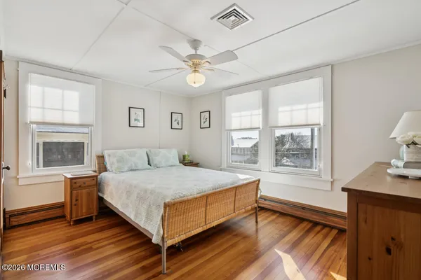 a bedroom with a bed dresser and a window