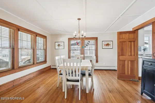a view of a dining room with furniture window and wooden floor