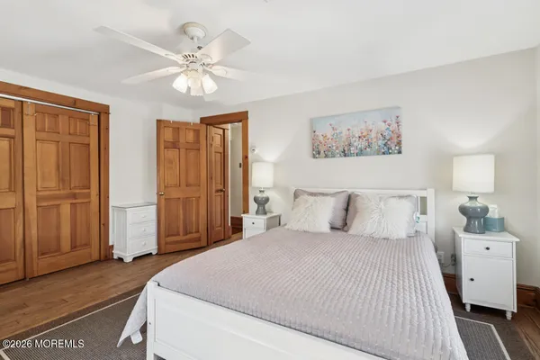 a bedroom with a large bed and a chandelier