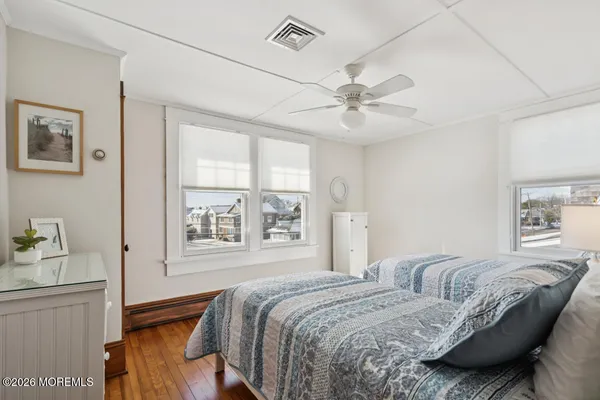 a bedroom with a bed dresser and a window