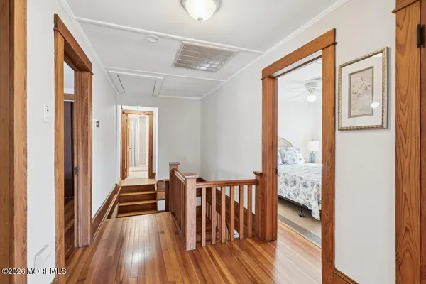 a view of a room with wooden floor and windows
