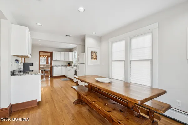 a room with furniture pool table and wooden floor