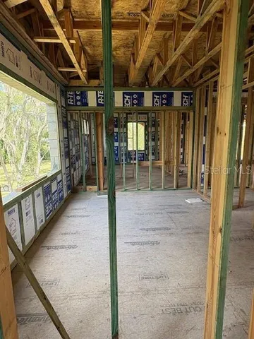 a living room with a fireplace and a large window