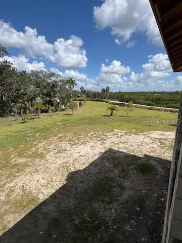a view of an empty room with a rug