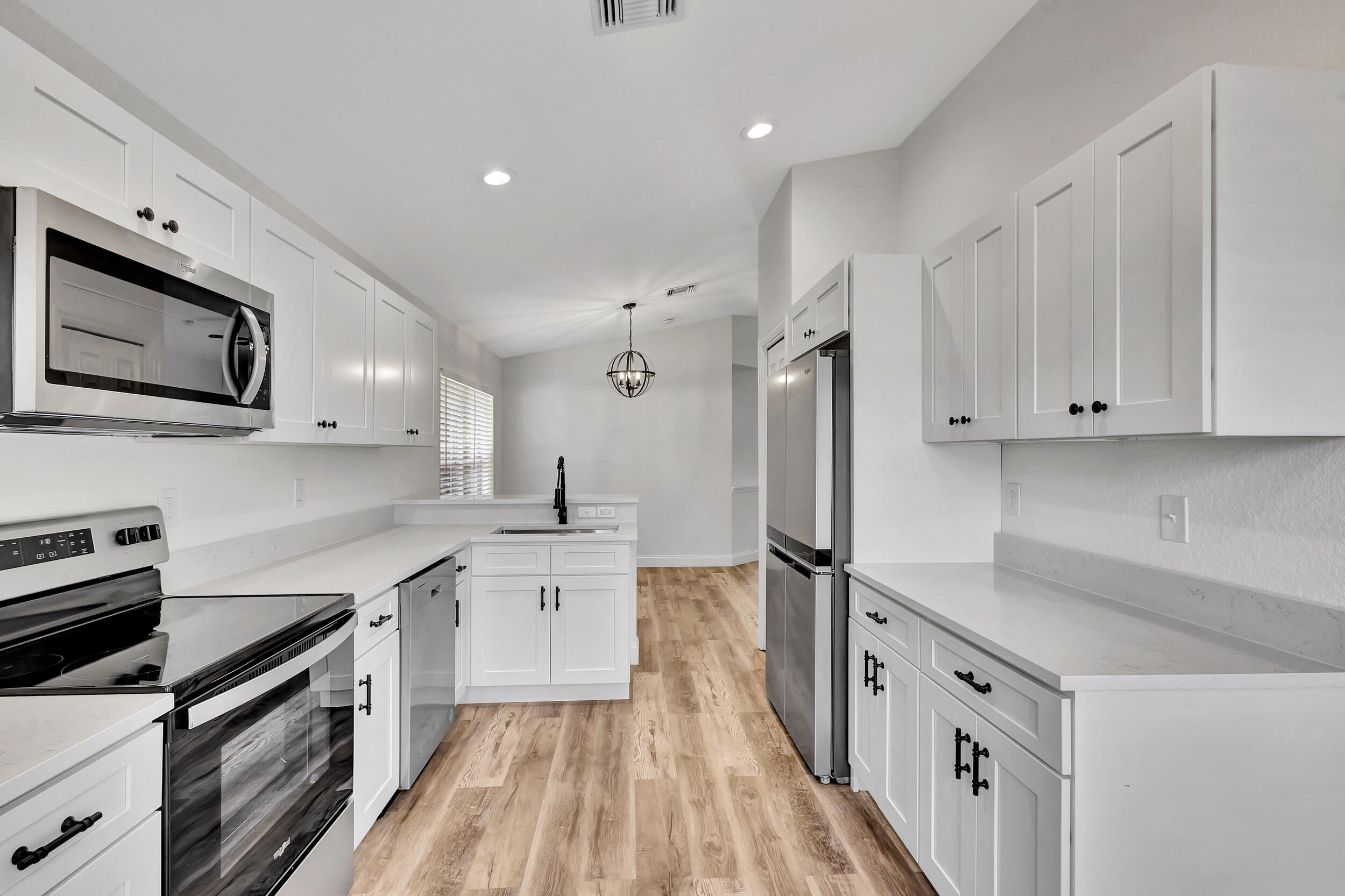 6746 3rd Street Limestone Creek, FL 33458 - Photo 16 of 60 a kitchen with stainless steel appliances a refrigerator sink and microwave