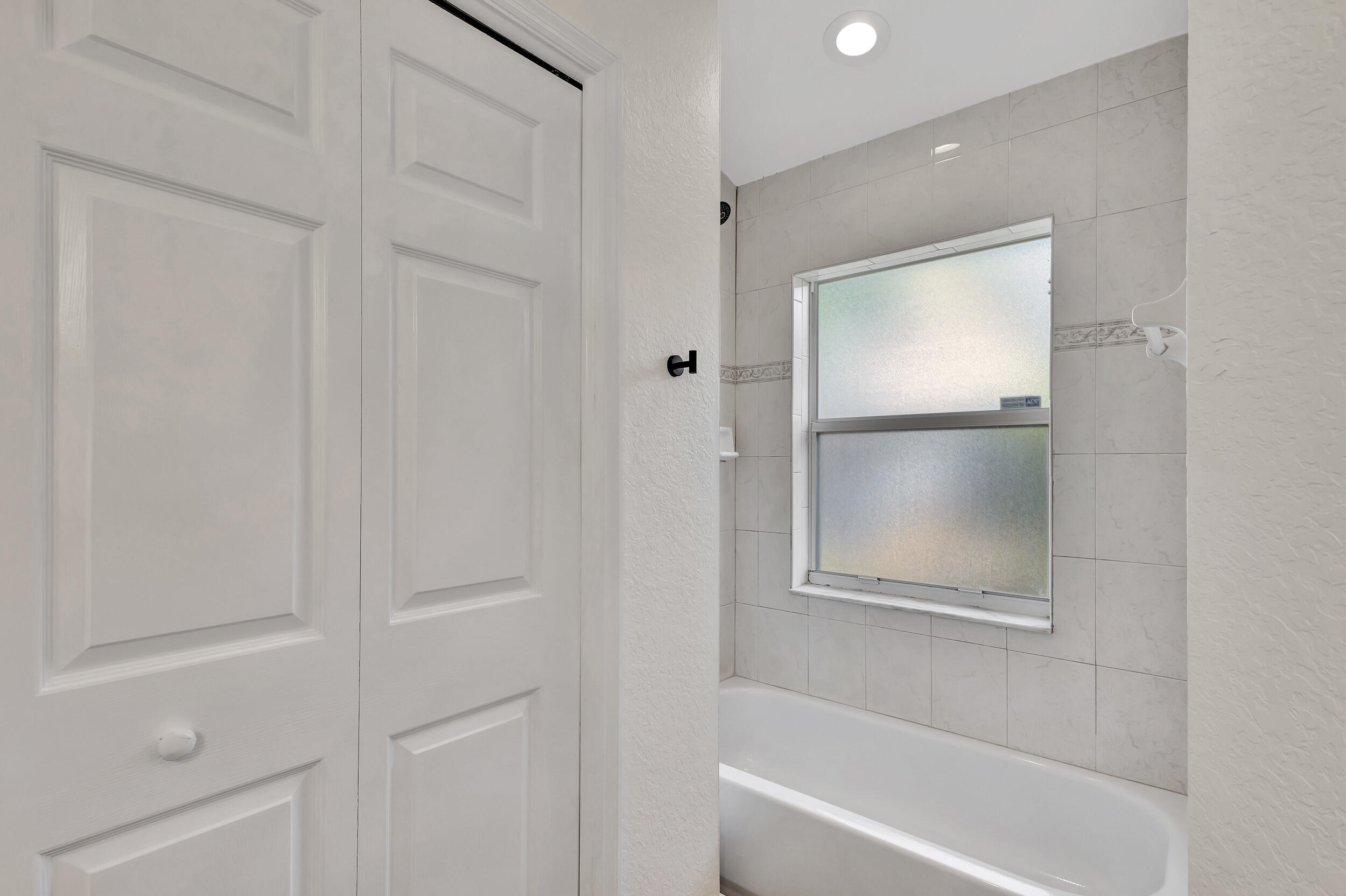 6746 3rd Street Limestone Creek, FL 33458 - Photo 29 of 60 a bathroom with a bathtub and a shower