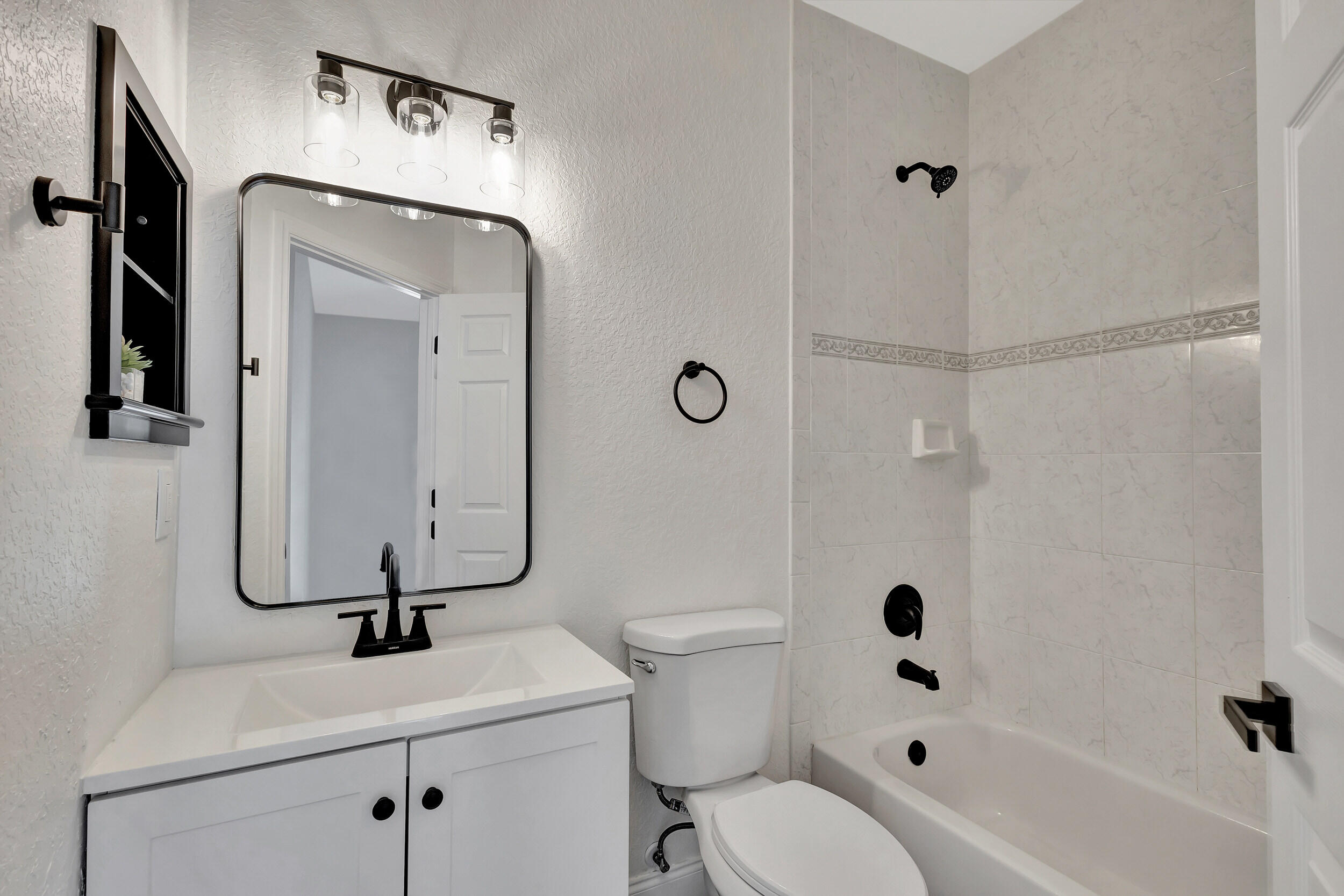 6746 3rd Street Limestone Creek, FL 33458 - Photo 34 of 60 a bathroom with a sink a toilet and shower