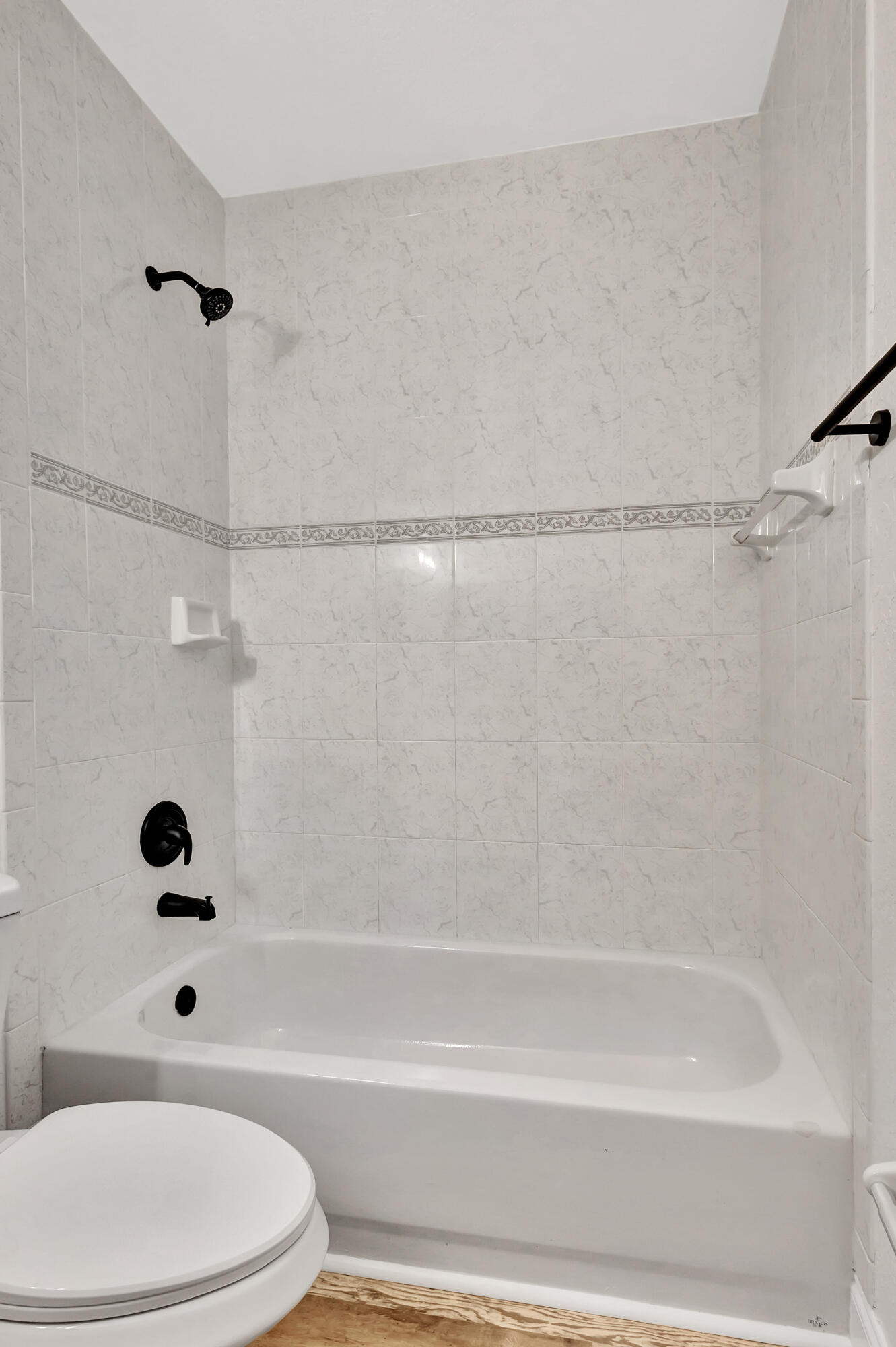 6746 3rd Street Limestone Creek, FL 33458 - Photo 36 of 60 a bathroom with a toilet and a bathtub