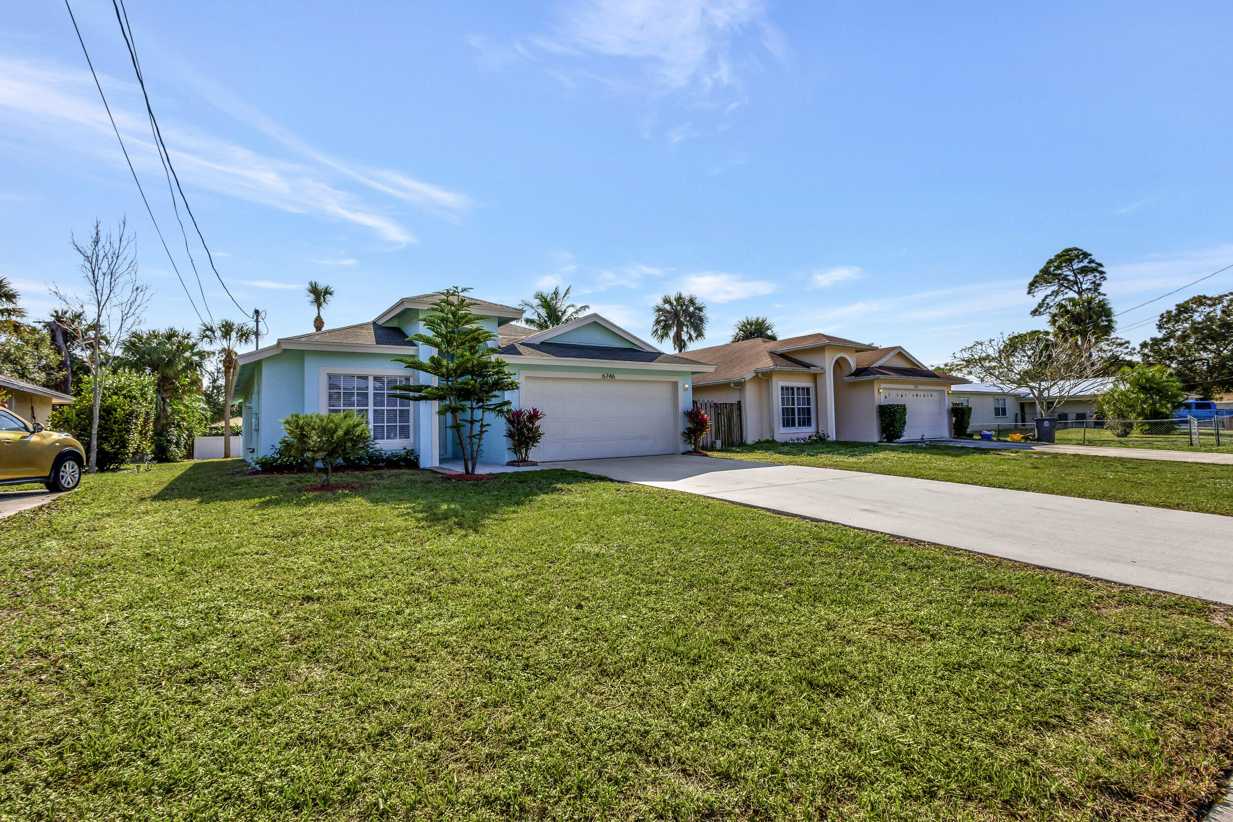 6746 3rd Street Limestone Creek, FL 33458 - Photo 4 of 60 a front view of a house with a garden