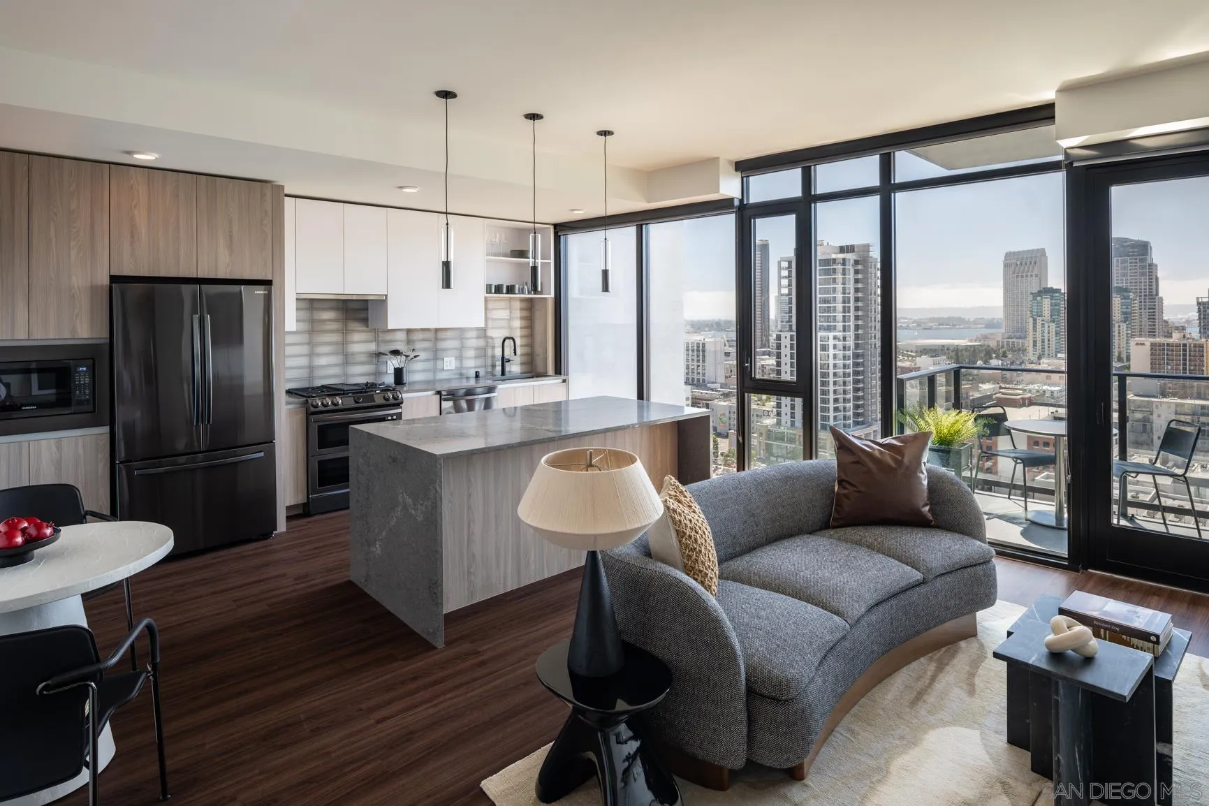 675 Ninth Avenue, Unit 2016 San Diego, CA 92101 - Photo 12 of 12 a kitchen with stainless steel appliances granite countertop a refrigerator a sink dishwasher a stove and a dining table with wooden floor