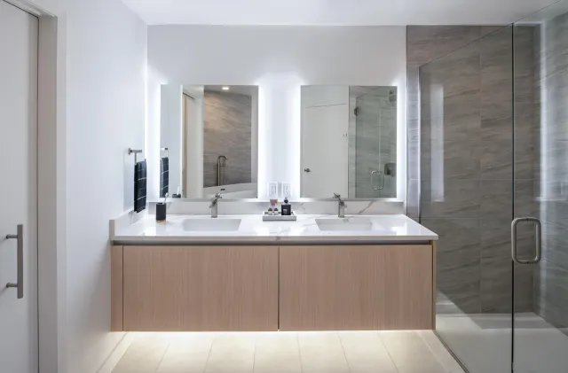 a bathroom with a double vanity sink and mirror
