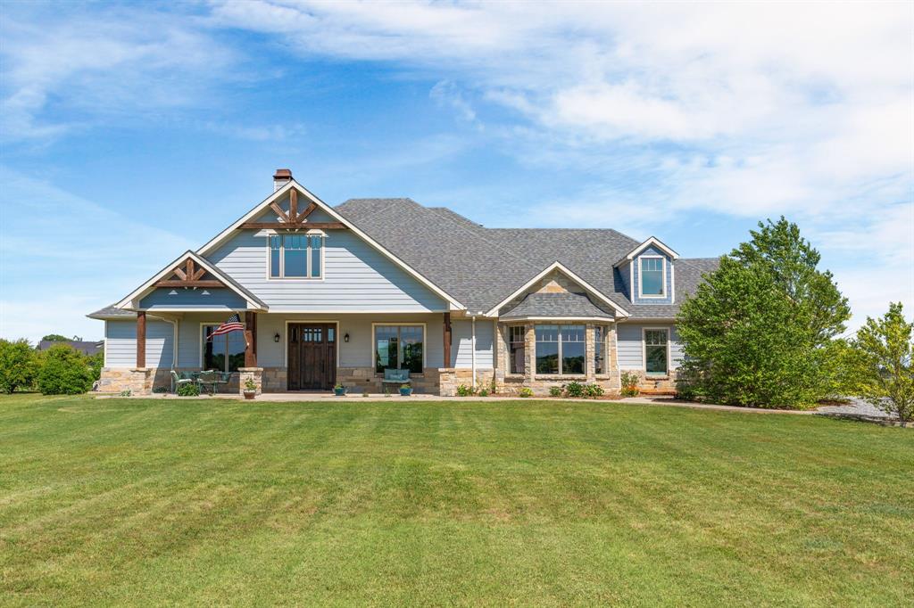 1206 Jc Maples Road Gunter, TX 75058 - Photo 1 of 40 a front view of a house with a yard table and chairs