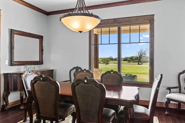 a view of a dining room with furniture a chandelier and wooden floor