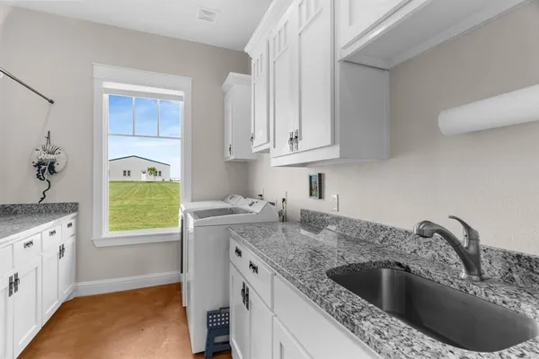 a spacious bathroom with a granite countertop sink a toilet and a mirror