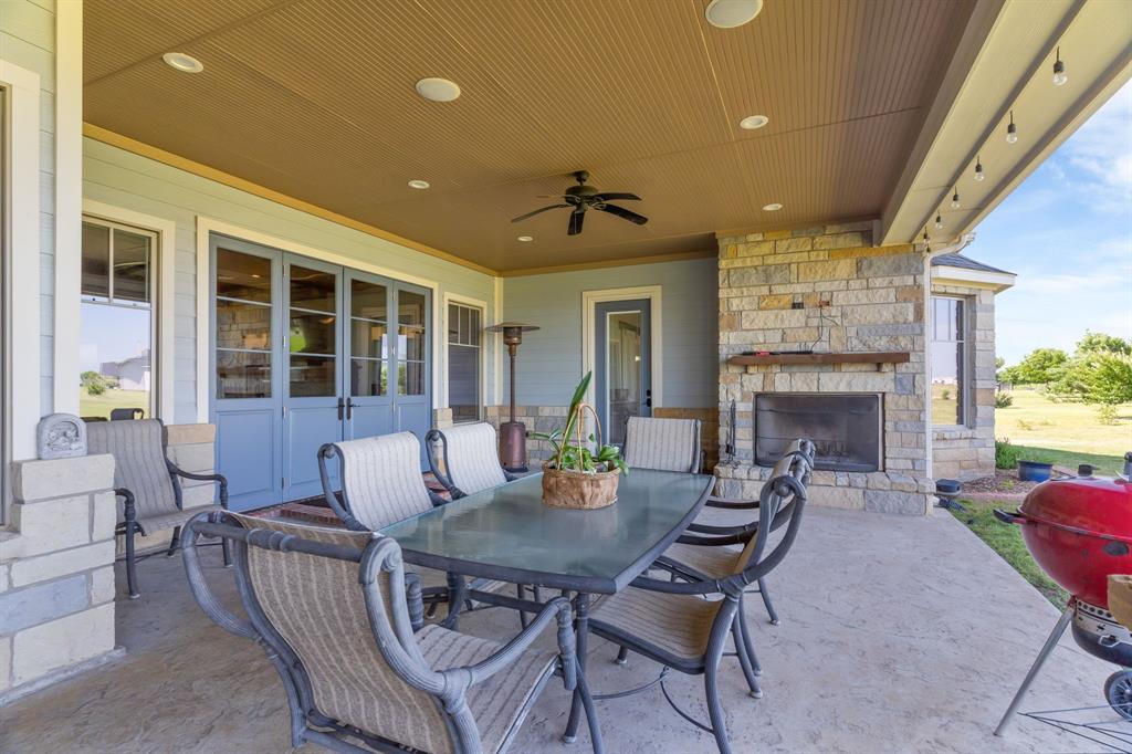 1206 Jc Maples Road Gunter, TX 75058 - Photo 18 of 40 a living room with furniture a fireplace and a table