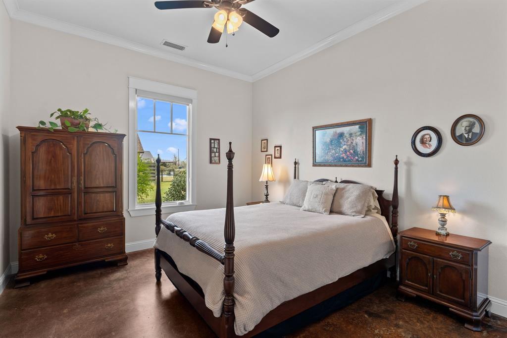 1206 Jc Maples Road Gunter, TX 75058 - Photo 20 of 40 a bedroom with a bed and a chandelier