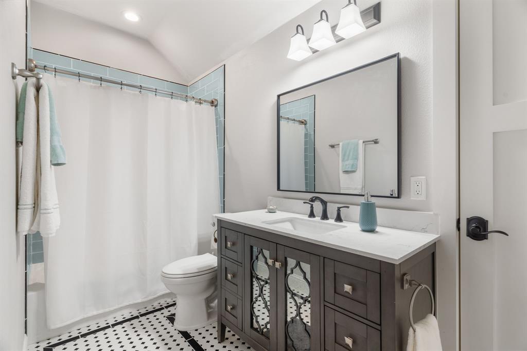 1206 Jc Maples Road Gunter, TX 75058 - Photo 23 of 40 a bathroom with a sink toilet double vanity and shower