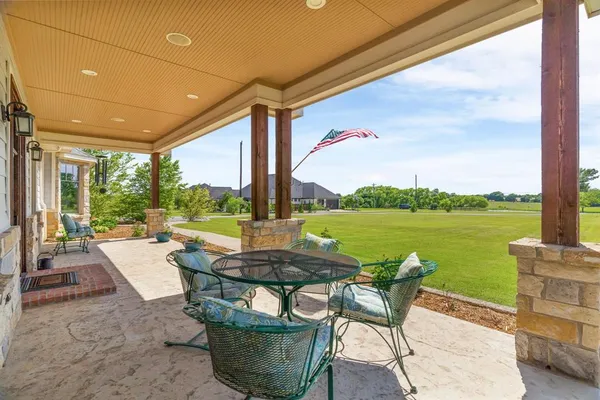 a patio with water view fountain and a table