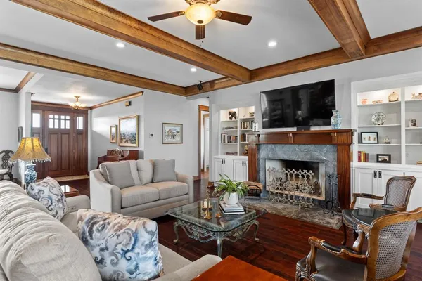 a living room with furniture a flat screen tv and a fireplace