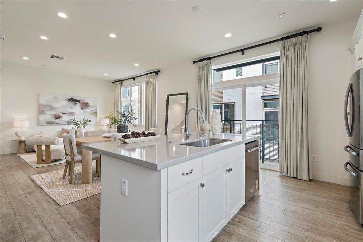 166 Nexus Loop San Jose, CA 95110 - Photo 12 of 29 a kitchen with counter top space sink and refrigerator