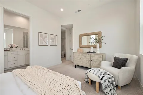 a bedroom with furniture and mirror