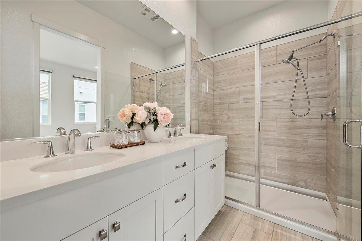 166 Nexus Loop San Jose, CA 95110 - Photo 19 of 29 a bathroom with a double vanity sink mirror and shower