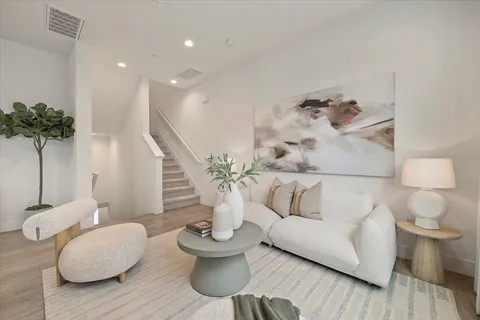 a living room with furniture and a potted plant