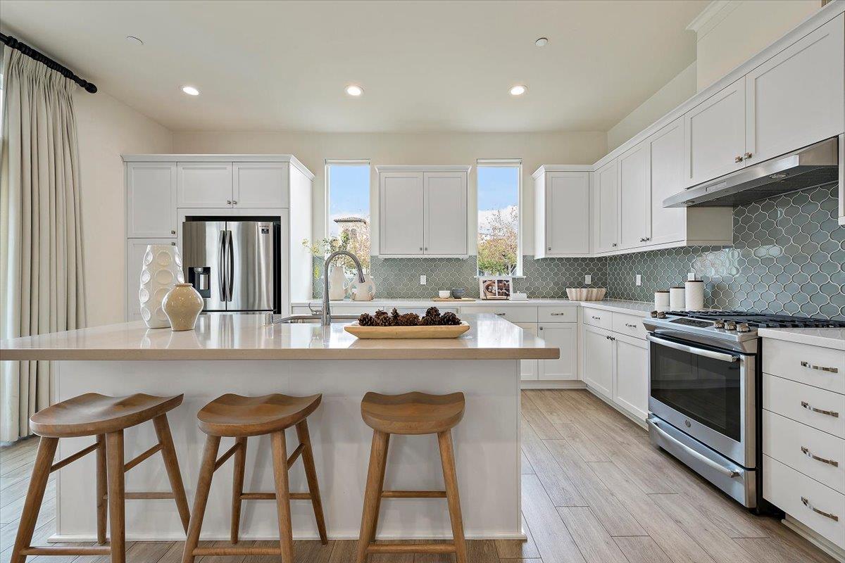 166 Nexus Loop San Jose, CA 95110 - Photo 9 of 29 a kitchen with stainless steel appliances granite countertop a stove a sink and a refrigerator