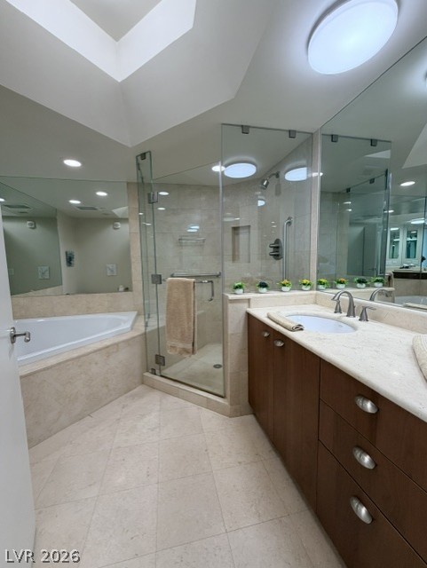 2777 Paradise Road, Unit 807 Las Vegas, NV 89109 - Photo 16 of 61 Marble tile flooring grounds this spa-like primary bathroom, featuring a deep soaking tub and a glass-enclosed shower.