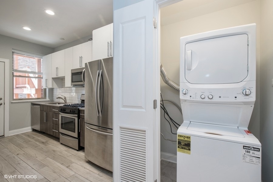 637 East 49th Street, Unit 3 Chicago, IL 60615 - Photo 6 of 7 a kitchen with a refrigerator washer and dryer