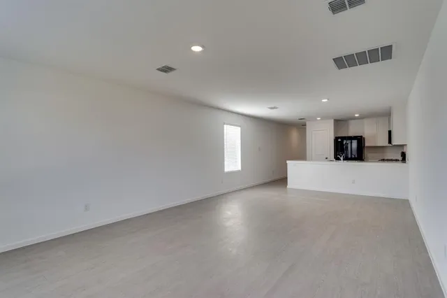 a view of a livingroom with kitchen appliances