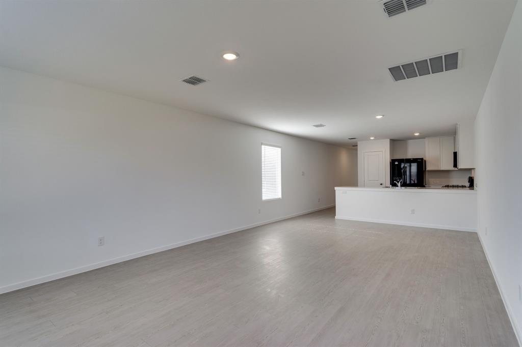 a view of a livingroom with kitchen appliances