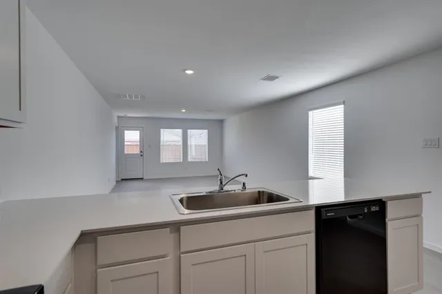 a kitchen with a sink and cabinets