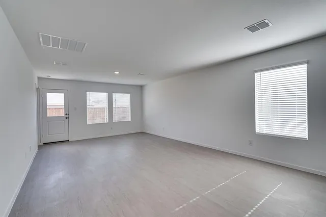 a view of an empty room with a window