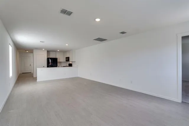 a view of a kitchen with a sink and a refrigerator
