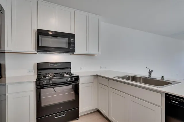 a kitchen with a sink and cabinets oven