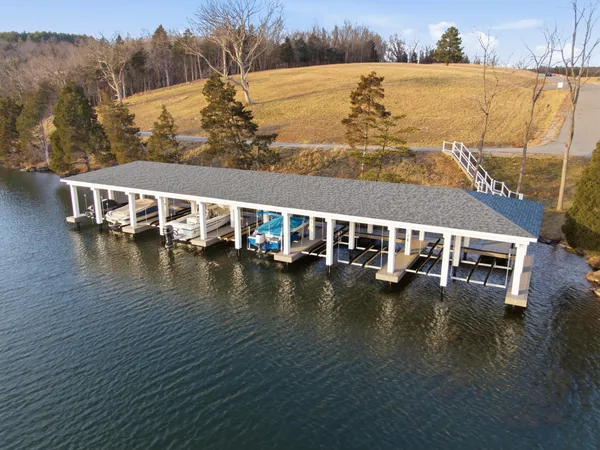 a bedroom with a bed a wall painting and a window