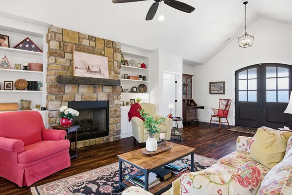 a view of a hallway with wooden floor and entryway