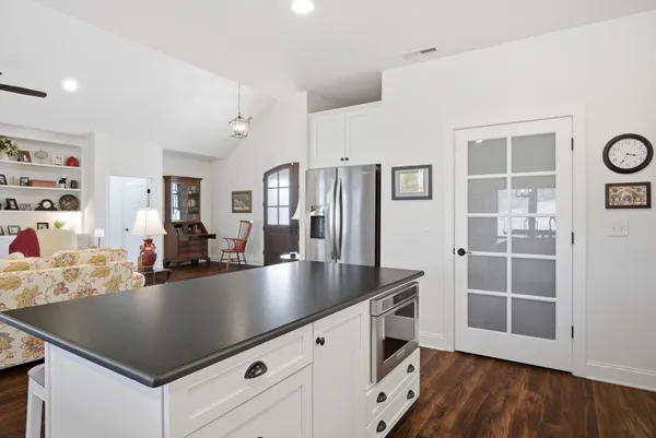 a bedroom with a bed and painting on the wall