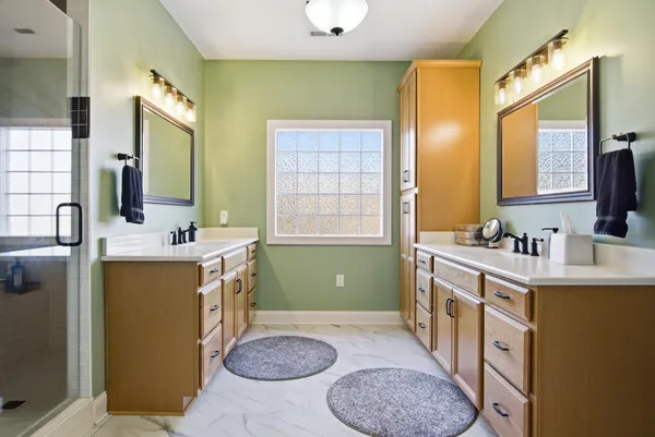 a spacious bedroom with a bed and a cabinets