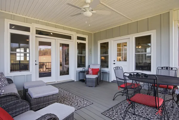 a living room with patio furniture and a floor to ceiling window